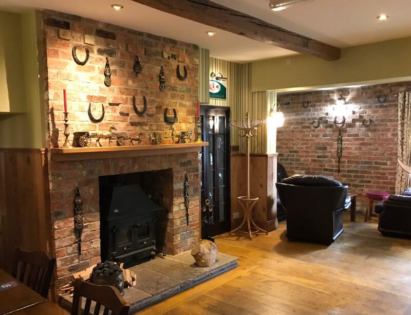 The Horseshoes Bar Area with fireplace and cosy seating